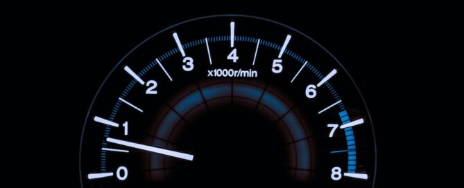 A close-up view of an automobile tachometer displaying RPM, with the needle pointing at approximately 1,000 RPM—vital information often reviewed by a car accident lawyer when investigating a collision for legal assistance.